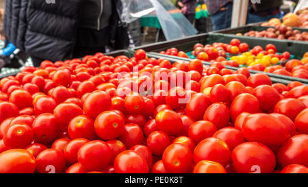Tomatos being purchased in Farmer's Market Stock Photo