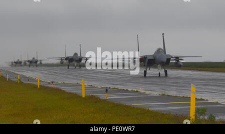 Four F-15C Eagle assigned to the 493rd Expeditionary Fighter Squadron taxi down the flightline after landing at Keflavik Air Base, Iceland, Aug. 3, 2018, in support of NATO’s Icelandic Air Surveillance mission. More than 250 U.S. Air Forces in Europe-Air Forces Africa Airmen and 14 F-15C/D Eagles deployed from Royal Air Force Lakenheath, England, with additional support from U.S. Airmen assigned to Aviano Air Base, Italy, Royal Air Force Mildenhall, England, and Ramstein Air Base, Germany. (U.S. Air Force photo/Staff Sgt. Alex Fox Echols III) Stock Photo