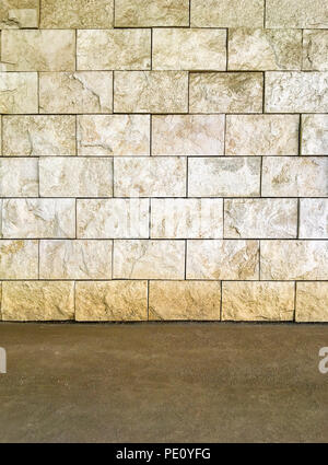 Rustic Travertine Stone textured wall with dirt soil ground floor background. Stock Photo