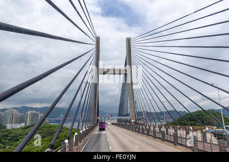 Tsing Ma double-decked suspension bridge between Ma Wan island and Tsing Yi island in Hong Kong, China by road view with sky background and copy space Stock Photo