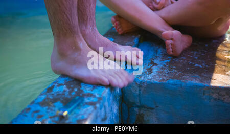 Two people enjoying themselves by the pool Stock Photo