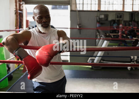 Senior man standing in the boxing ring Stock Photo