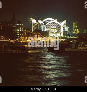 Charing Cross railway station, London, at night from across the river Thames Stock Photo