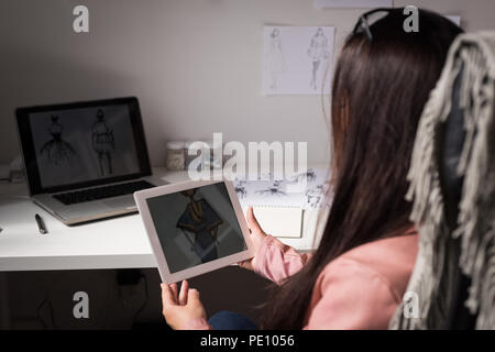 Fashion designer using laptop Stock Photo