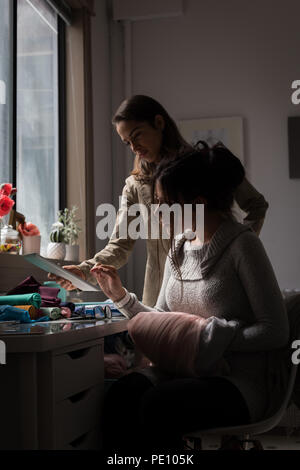 Fashion designers discussing over laptop Stock Photo