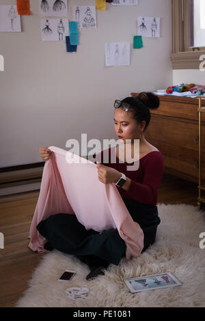 Fashion designer checking fabric Stock Photo