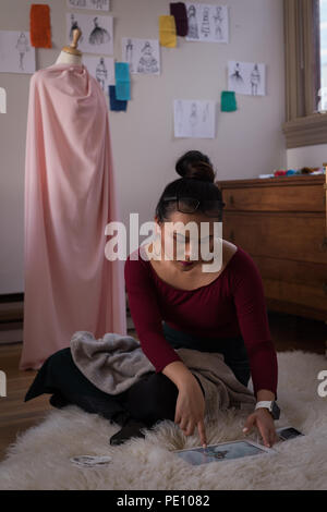 Fashion designer using digital tablet Stock Photo