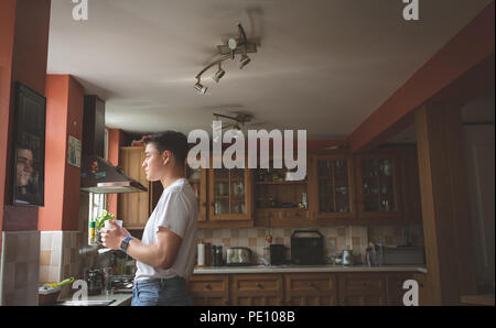 Man having coffee in the kitchen