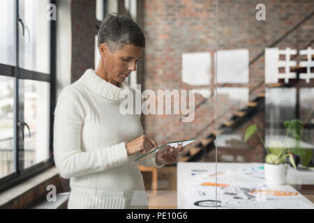 Businesswoman using glass digital tablet Stock Photo