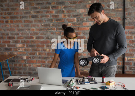Father explaining his daughter about electric model car Stock Photo