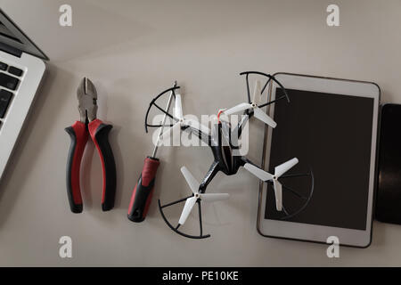 Drone, tools and digital tablet on a table Stock Photo