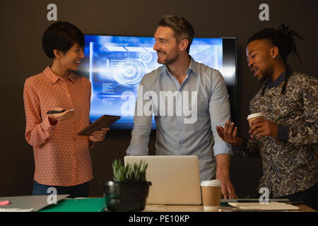 Executives discussing with each other in conference room at office Stock Photo