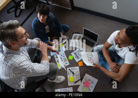 Colleagues discussing about the work over documents Stock Photo