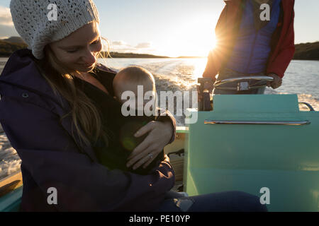 Mother with her baby travelling on motor boat Stock Photo