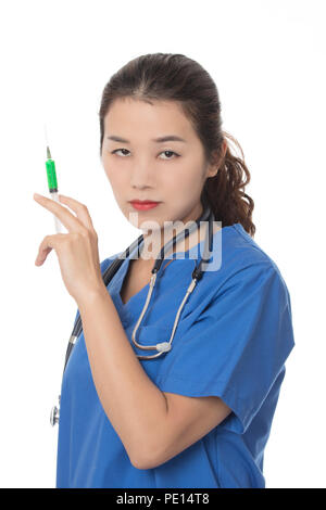 Evil Asian doctor or nurse holding a syringe filled with green medication isolated on a white background Stock Photo