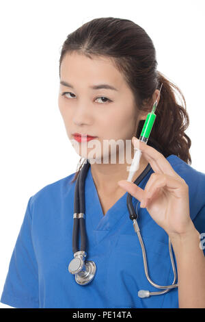 Evil Asian doctor or nurse holding a syringe filled with green medication isolated on a white background Stock Photo