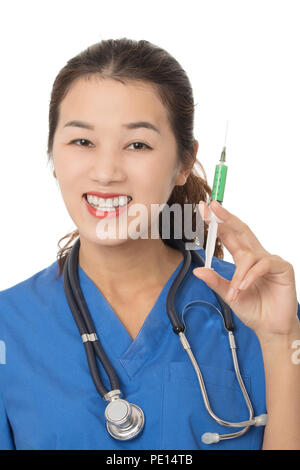 Evil Asian doctor or nurse holding a syringe filled with green medication isolated on a white background Stock Photo