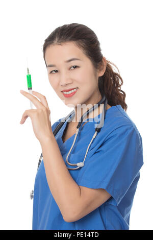 Evil Asian doctor or nurse holding a syringe filled with green medication isolated on a white background Stock Photo