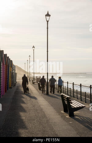 Tourists walking along the promenade at Saltburn-by-the-sea on a beautiful spring evening. North Yorkshire, England. Stock Photo