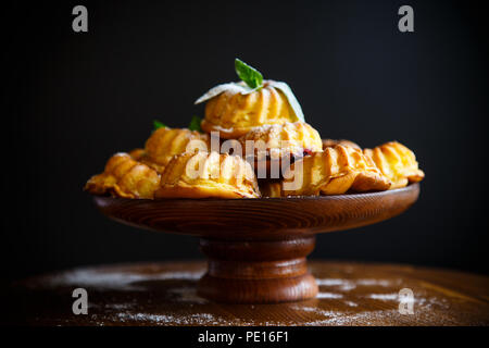 sweet muffin curd in sugar powder on the table Stock Photo