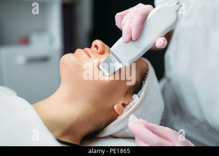 Getting rid of wrinkles in cosmetology clinic. Facial skincare in spa salon, health care. Rejuvenation procedure, beauty medicine Stock Photo