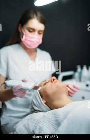 Getting rid of wrinkles in cosmetology clinic. Facial skincare in spa salon, health care. Rejuvenation procedure, beauty medicine Stock Photo