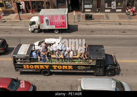 Group of party people  drinking cocktails on a bus at daytime on Broadway in Nashville Stock Photo