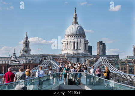 St.Paul's cathedral as viewed from South of Thames river side with tourists on the millennium bridge Stock Photo