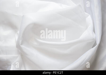 White Synthetic Lining Fabric with Folds. Crumpled Sheet or Clothes Background, Stock Photo
