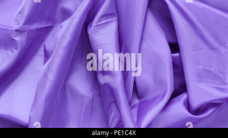 Purple Synthetic Lining Fabric with Folds. Crumpled Sheet or Clothes Background, Stock Photo