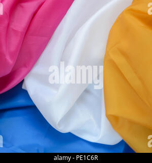 Multicolor Four Different Colors Synthetic Lining Fabric with Folds Background Stock Photo