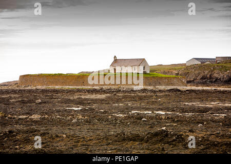 UK, Wales, Anglesey, Aberffraw, St Cwyfan's Church, on Cribinau Island surrounded by sea wall at low tide