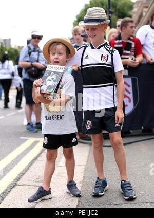 Young Fulham fans Monty McTarron (left) and Barney McTarron, aged 6 and 9 respectively, outside the ground during the Premier League match at Craven Cottage, London. Stock Photo