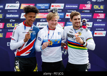 Great Britain's gold medalist Kyle Evans (right) and Great Britain's silver medalist Kye Whyte with bronze medalist France's Sylvain Andre (right) after the Men's BMX Final during day ten of the 2018 European Championships at the Glasgow BMX Centre Track. Stock Photo