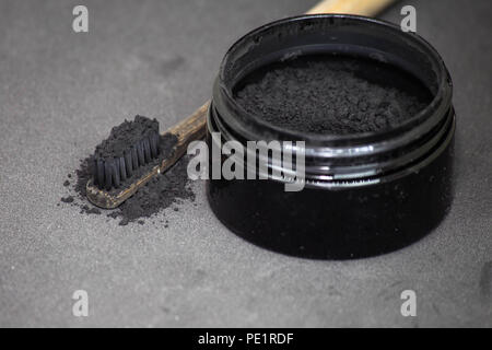 Charcoal on a toothbrush to whiten teeth Stock Photo