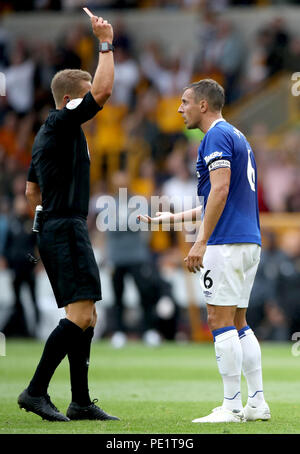 Referee Craig Pawson shows a red card to Everton's Phil Jagielka after a tackle on Wolverhampton Wanderers' Diogo Jota (not in picture) during the Premier League match at Molineux, Wolverhampton. Stock Photo