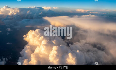 Large White Cloud From Passanger Airplace Window At Sunset Stock Photo