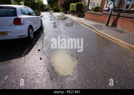 Bexley, London, UK. 11th August 2018. Recent heatwave causes pothole and broken water pipe in Upton Road South, Bexley in South East London. Steve Hickey/AlamyLive News