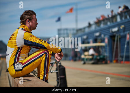 Corby, Northamptonshire, UK, 12th August 2018. ex BTCC racing driver and  ITV Sport presenter Paul O'Neill during the Dunlop MSA British Touring Car  Championship at Rockingham Motor Speedway. Photo by Gergo Toth /