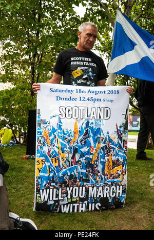 Glasgow, Renfrewshire, UK. 11th Aug, 2018. A man stands with a poster for an independence march.Hundreds of demonstrators took to the street of Glasgow to protest against the BBC for the misrepresentation of Scotland and the bias news that is in favor of Westminster. Credit: Stewart Kirby/SOPA Images/ZUMA Wire/Alamy Live News Stock Photo