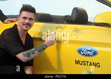 Marbella, Spain 11th August 2018. Donation of a Ford Mustang at the Starlite charity gala, signed by Colombian singer Juanes and Spanish actor Antonio Banderas in Marbella, Spain on August 11, 2018  Carnero / 692 / Cordon Press    Juanes Credit: CORDON PRESS/Alamy Live News Stock Photo