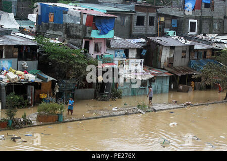 Marikina City, Philippines. 12th Aug, 2018. Shanties are submerged in flood brought by tropical storm Yagi in Marikina City, the Philippines, Aug. 12, 2018. Credit: Rouelle Umali/Xinhua/Alamy Live News Stock Photo