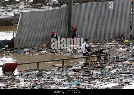 Marikina City, Philippines. 12th Aug, 2018. Residents wade through the flood brought by tropical storm Yagi as they look for their belongings in Marikina City, the Philippines, Aug. 12, 2018. Credit: Rouelle Umali/Xinhua/Alamy Live News Stock Photo