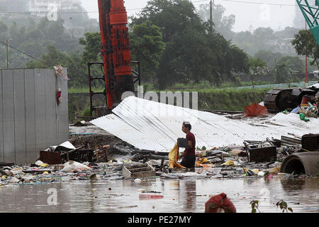 Marikina City, Philippines. 12th Aug, 2018. A resident wades through the flood brought by tropical storm Yagi in Marikina City, the Philippines, Aug. 12, 2018. Credit: Rouelle Umali/Xinhua/Alamy Live News Stock Photo