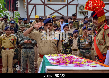 August 12, 2018 - Srinagar, Jammu & Kashmir, India - Indian police officer salute during the wreath-laying ceremony of their colleague Parvaiz Ahmad in Srinagar. A gunfight between rebels and raiding government forces at a neighborhood in Indian-controlled Kashmir's main city on Sunday has killed a counterinsurgency police official and wounded at least three other security officials, police said.A gunfight between rebels and raiding government forces at a neighborhood in Indian-controlled Kashmir's main city on Sunday has killed a counter insurgency police official and wounded at least three Stock Photo