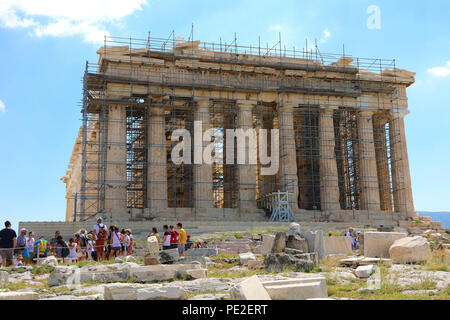 ATHENS, GREECE - JULY 18, 2018: Parthenon temple under renovation with tourists visiting the Acropolis in Athens, Greece Stock Photo