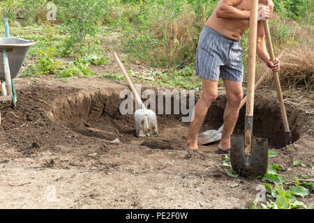 Workers dig a pit for a septic tank in a private house Stock Photo