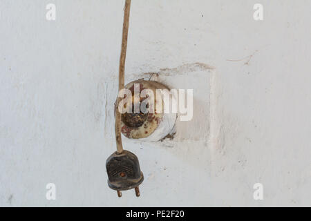 Old fork and socket on the wall of the house Stock Photo