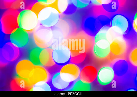 christmas and new year concept - Defocused abstract multicolored bokeh lights background. Blue, purple, green, orange colors. Stock Photo