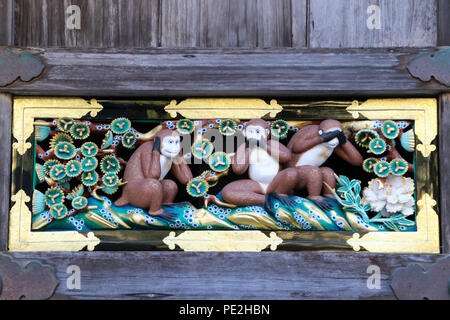 The original and famous three wise monkeys carving at the horse stable of the Tōshō-gū Shinto shrine located in Nikkō, Tochigi Prefecture, Japan. Stock Photo